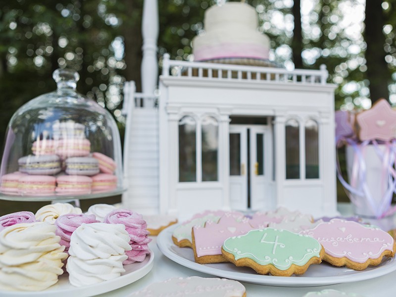 Dessert table for a party. Cake, cupcakes, sweetness and flowers. Shallow dof