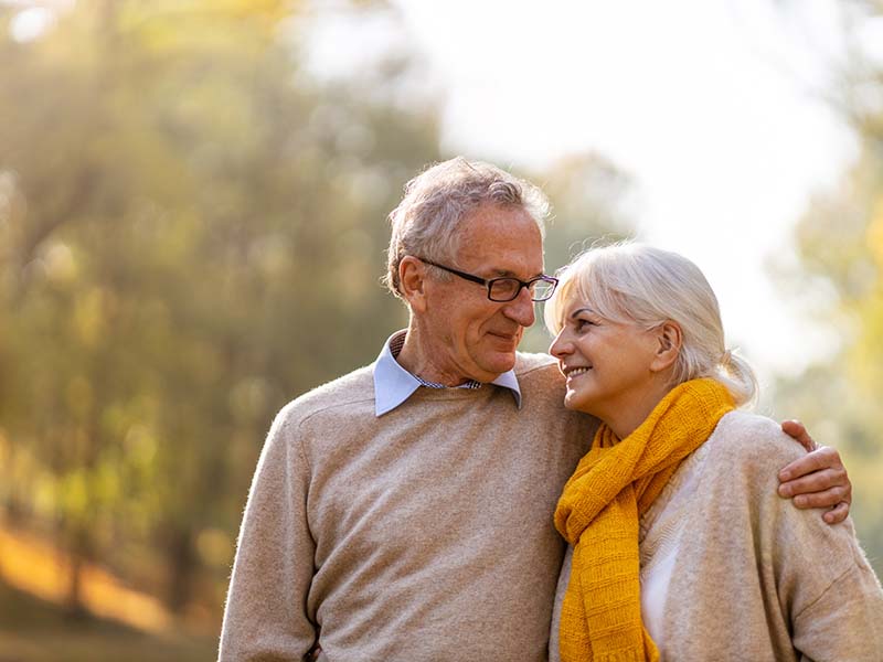 Happy senior couple in autumn park