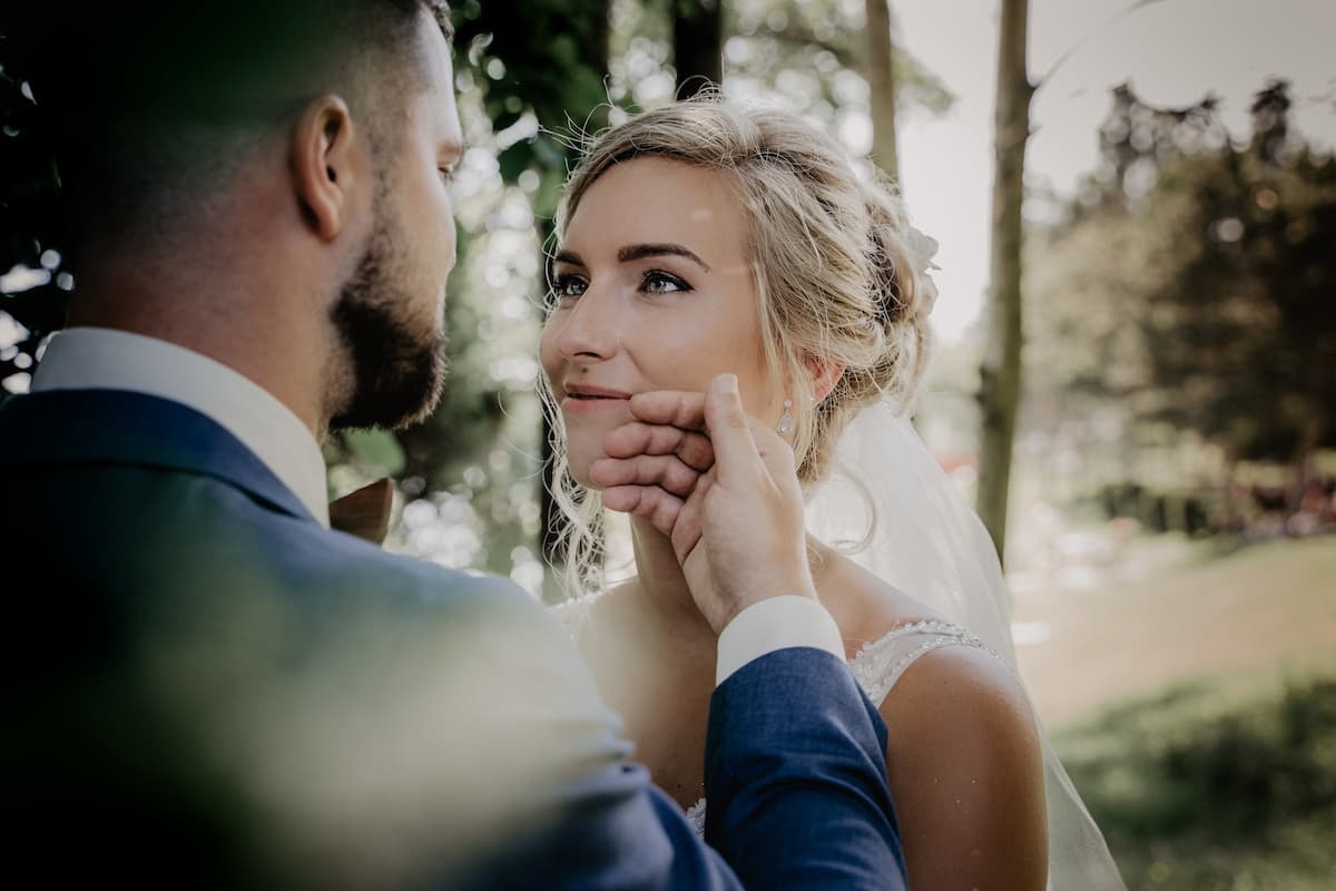 Homem de terno azul com mulher de vestido de noiva
